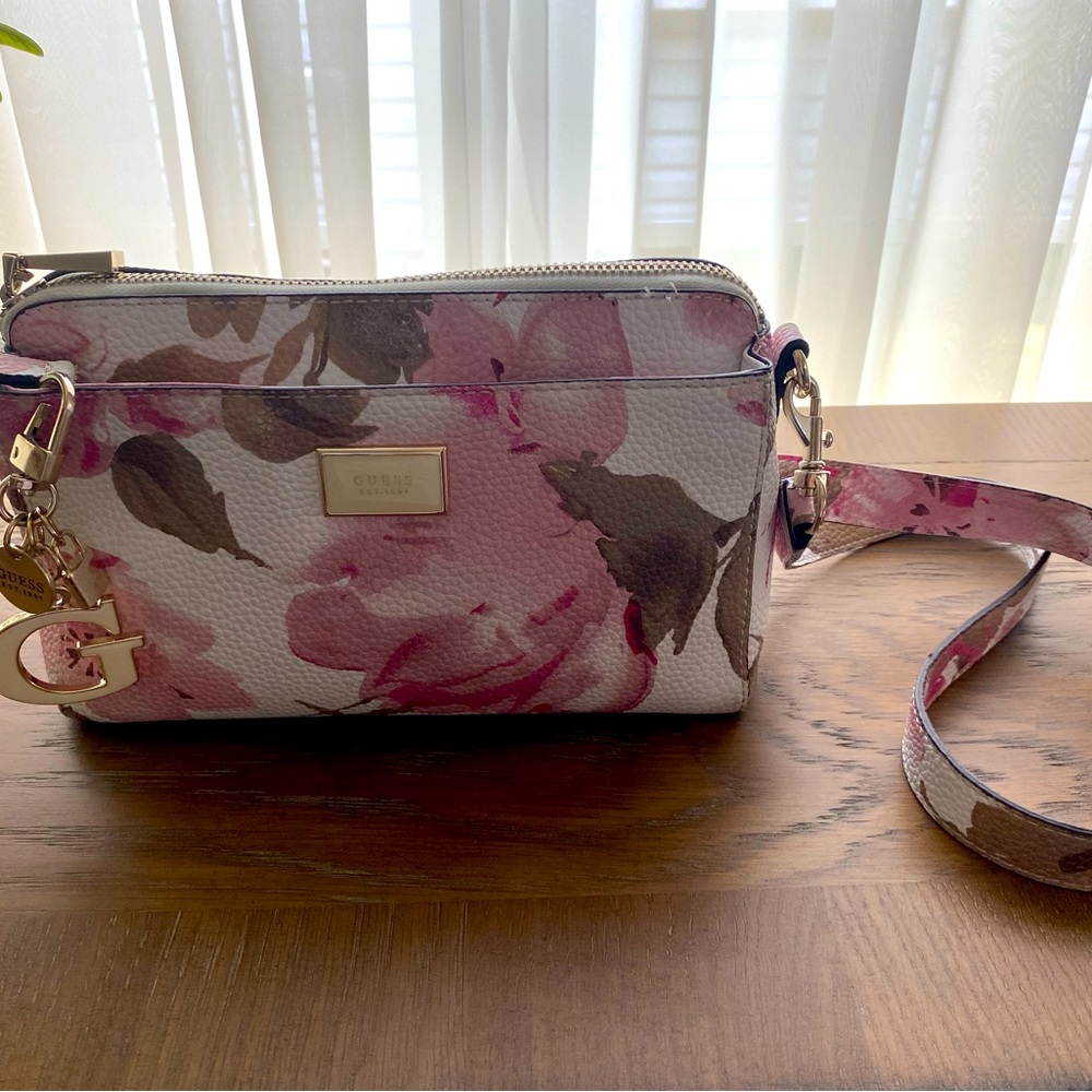 Pink and white floral Guess bag with 3 pockets.